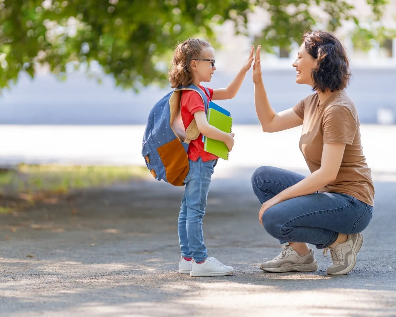 Madre despidiéndose de su hija agachada a su altura, mostrando conexión, respeto y comprensión — símbolo de una crianza neurodivergente basada en empatía y validación emocional.