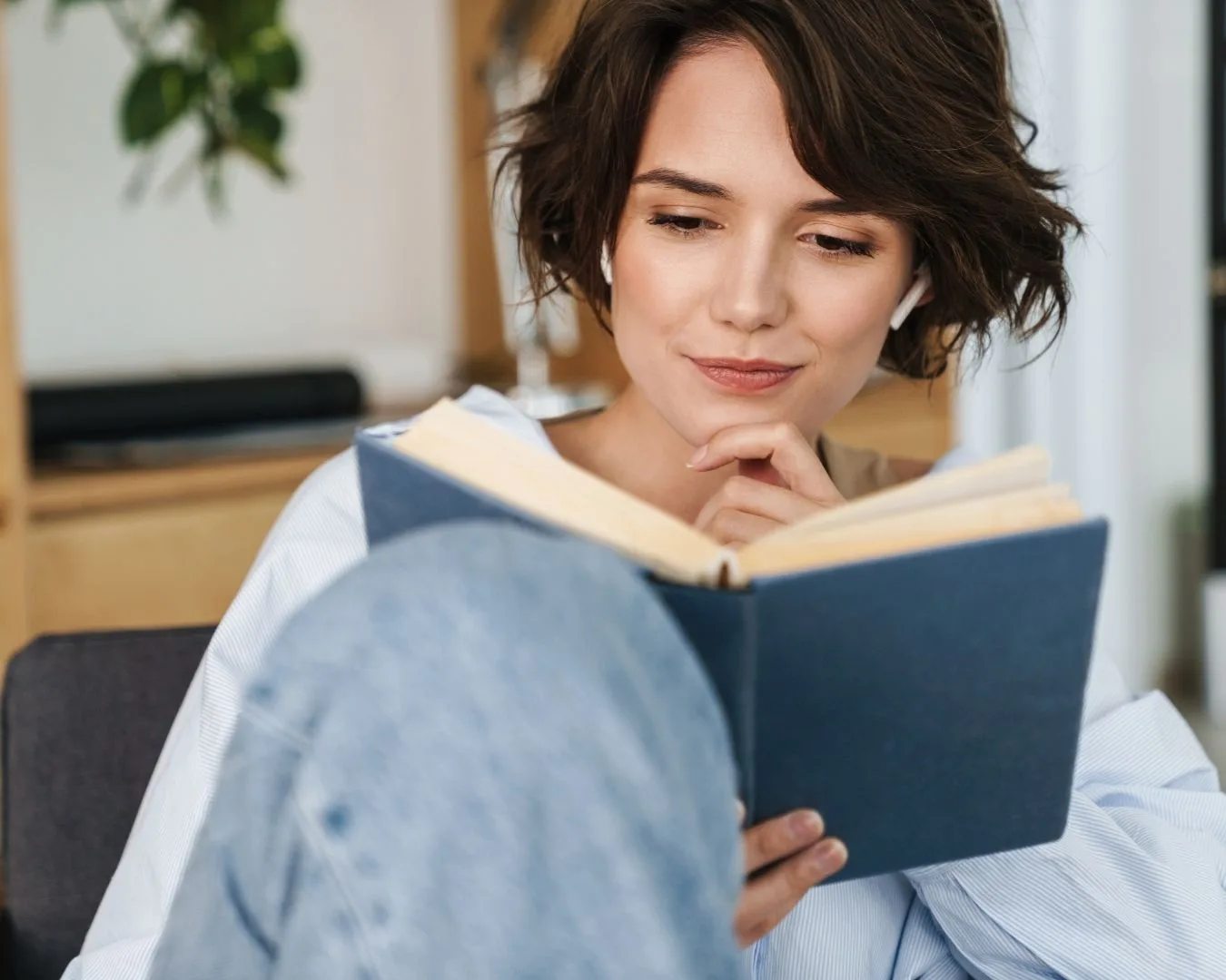 Mujer leyendo en un espacio luminoso, símbolo de conocimiento y confianza — evidencia científica que valida y empodera la crianza neurodivergente.